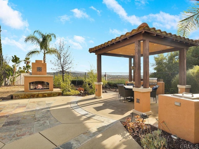 view of patio / terrace with a gazebo and an outdoor fireplace