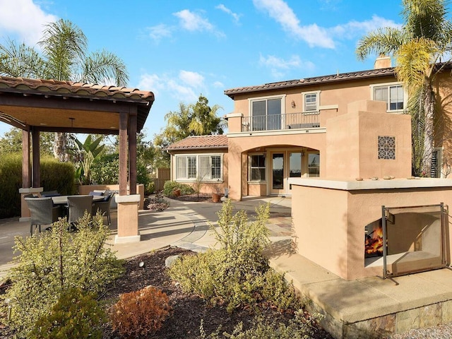 back of house featuring a patio area and a balcony