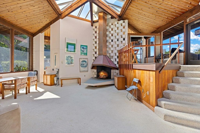 sunroom / solarium with vaulted ceiling with skylight and wood ceiling