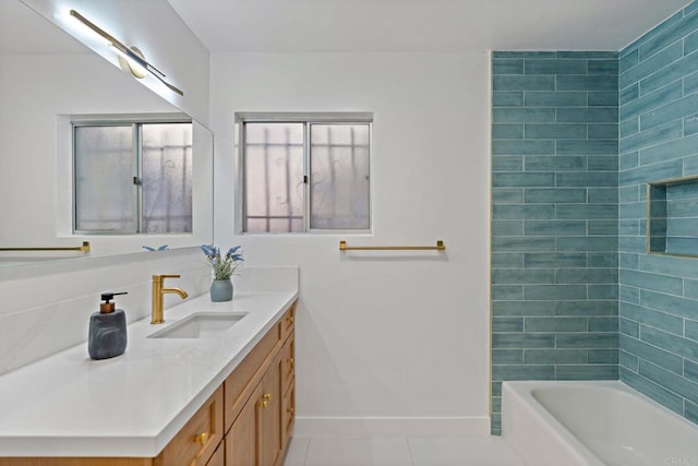 bathroom featuring tile patterned flooring, tiled shower / bath combo, and vanity