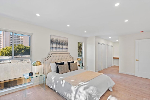 bedroom with light hardwood / wood-style flooring and a closet