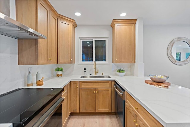 kitchen with dishwasher, wall chimney range hood, black range with electric cooktop, sink, and light hardwood / wood-style flooring