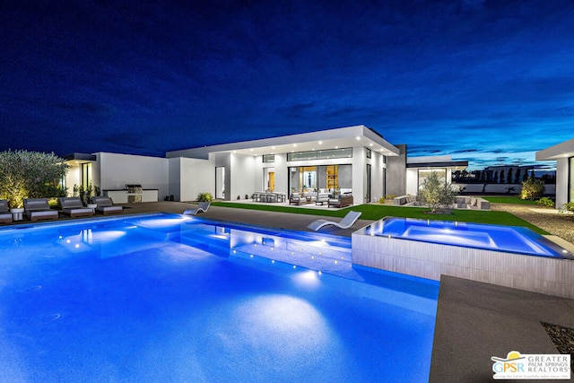 pool at dusk with a patio area and outdoor lounge area