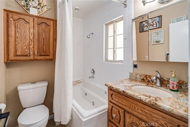 bathroom with toilet, a combined bath / shower with jetted tub, and vanity