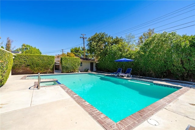 view of swimming pool with a patio area and an in ground hot tub