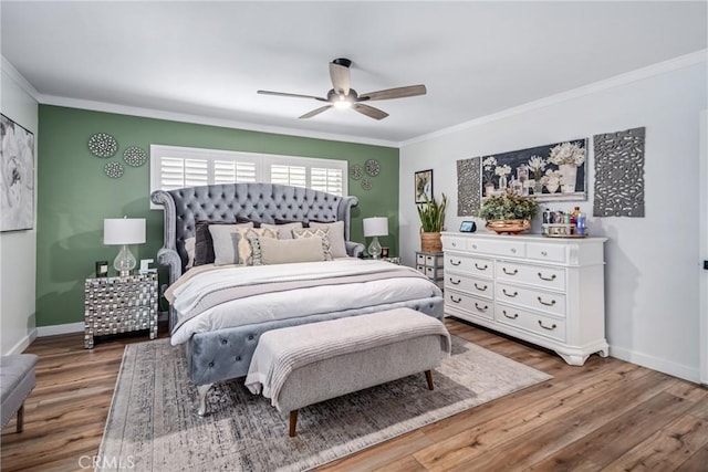 bedroom featuring ceiling fan, crown molding, and hardwood / wood-style flooring