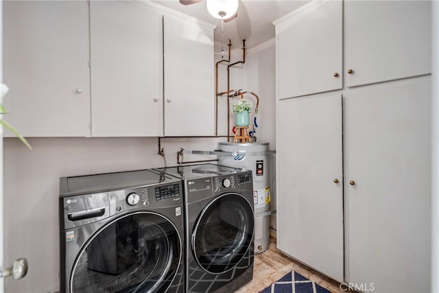 laundry room featuring cabinets, strapped water heater, and separate washer and dryer