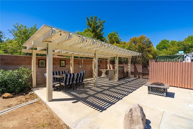 view of patio with a pergola and a fire pit