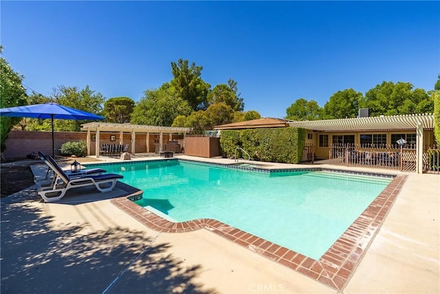 view of swimming pool featuring a patio area and a pergola