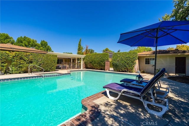 outdoor pool with a patio area