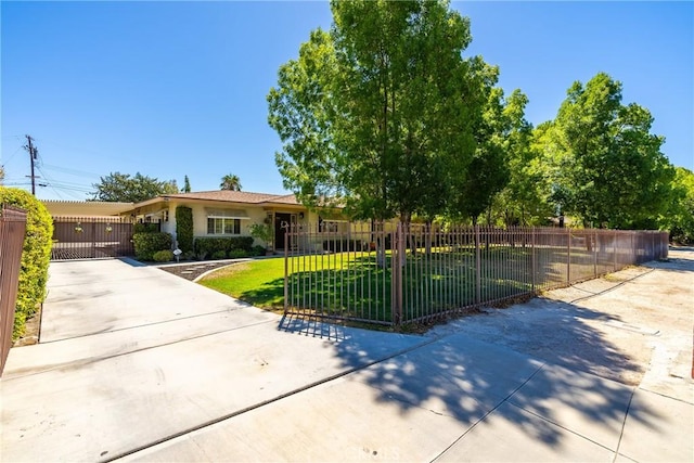 ranch-style house with a gate, a fenced front yard, driveway, and a front yard