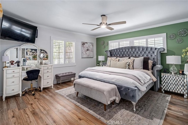 bedroom with ceiling fan, ornamental molding, and light hardwood / wood-style flooring