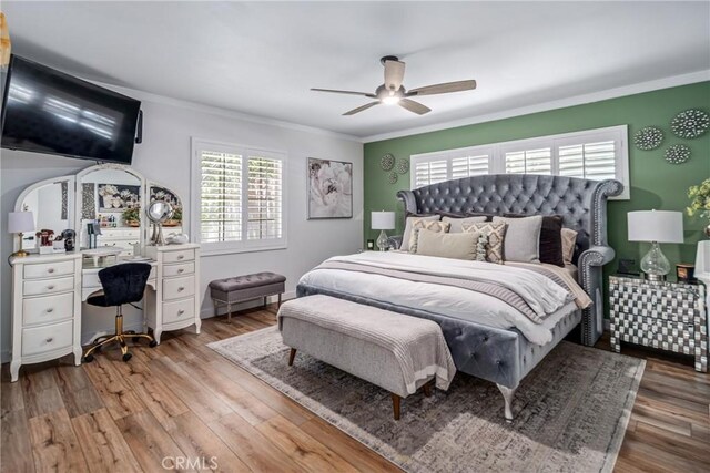 bedroom with ornamental molding, a ceiling fan, and light wood-type flooring