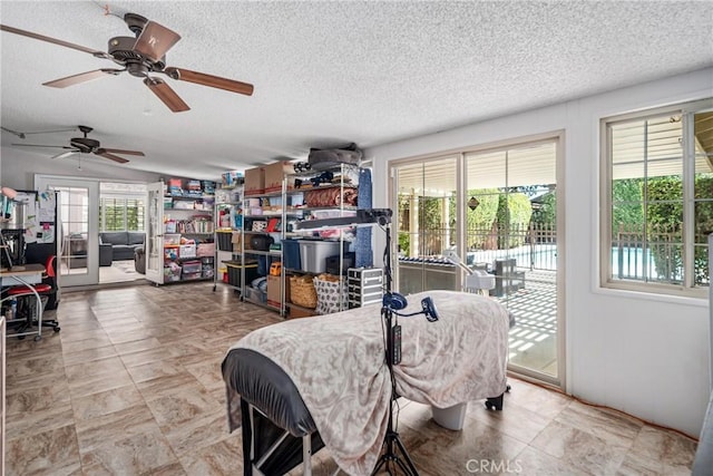 dining space featuring ceiling fan and a textured ceiling