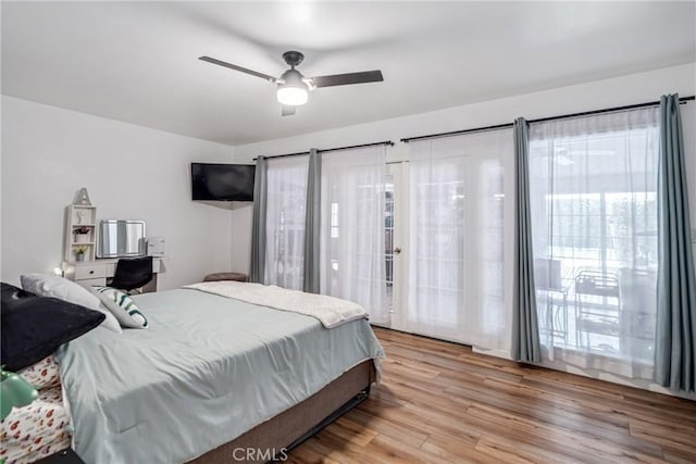 bedroom with ceiling fan, access to outside, and light hardwood / wood-style flooring