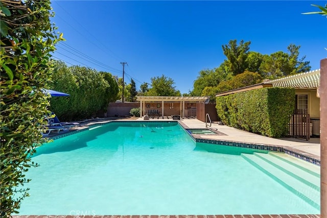 pool with a pergola, an in ground hot tub, fence private yard, and a patio area