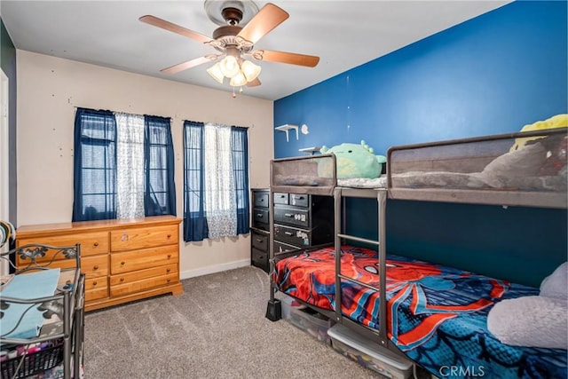 carpeted bedroom featuring ceiling fan and baseboards