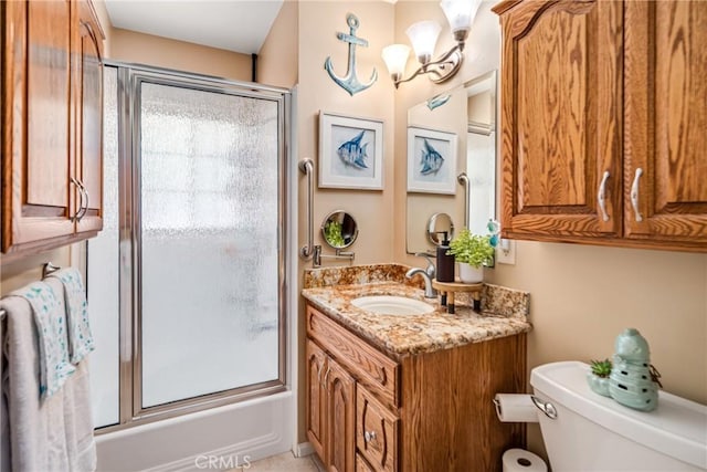 full bathroom featuring combined bath / shower with glass door, vanity, toilet, and a chandelier