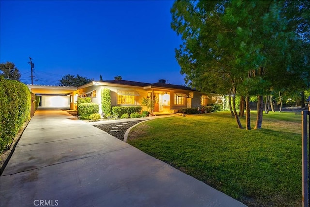 single story home featuring stucco siding, a front yard, and concrete driveway