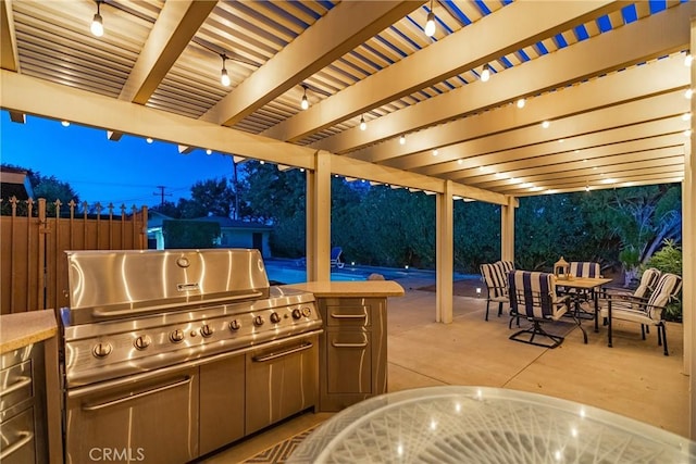 view of patio / terrace with fence, grilling area, a pergola, exterior kitchen, and outdoor dining space