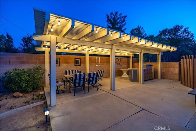 view of patio / terrace featuring fence, a pergola, and outdoor dining area