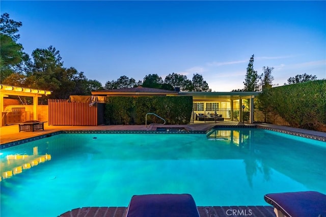view of swimming pool with a fenced in pool and fence