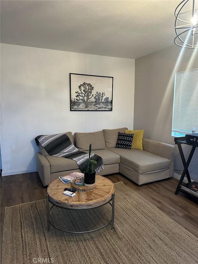 living room with baseboards and wood finished floors