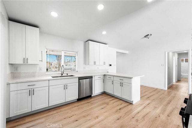 kitchen with white cabinets, dishwasher, sink, and light hardwood / wood-style flooring