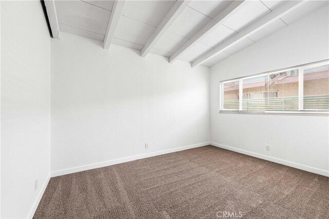 carpeted spare room with lofted ceiling with beams