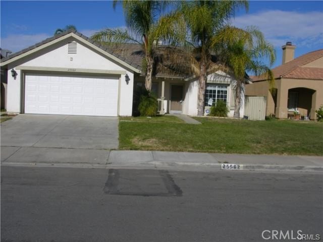 view of front of property with a garage and a front yard