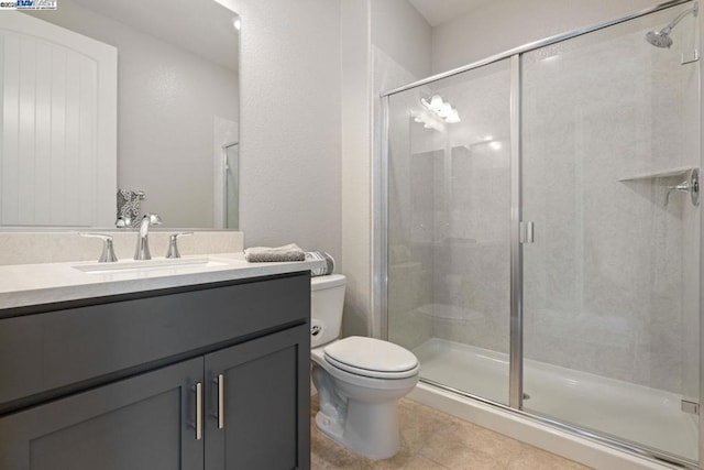 bathroom with toilet, a shower with door, tile patterned floors, and vanity