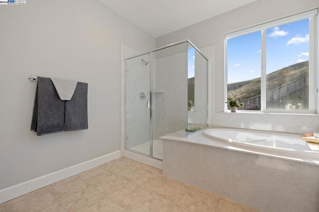 bathroom with tile patterned floors and separate shower and tub