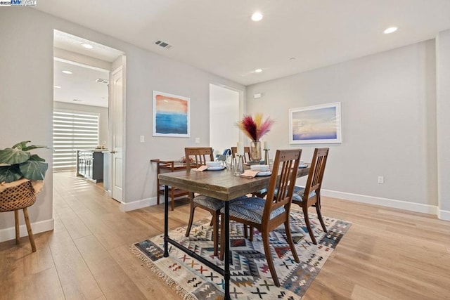 dining space with light hardwood / wood-style flooring