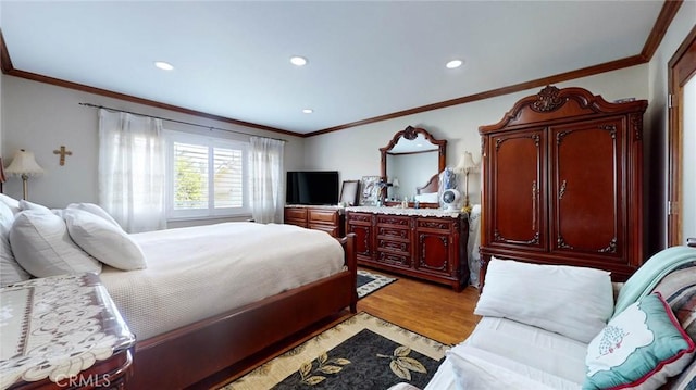 bedroom with light hardwood / wood-style floors and crown molding