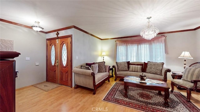 living room featuring an inviting chandelier, crown molding, and light hardwood / wood-style flooring