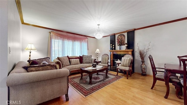 living room featuring hardwood / wood-style floors, ornamental molding, and a chandelier