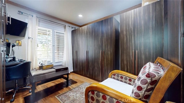 interior space featuring crown molding and light hardwood / wood-style flooring