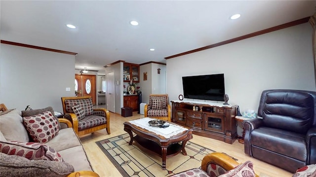 living room with crown molding and light hardwood / wood-style floors