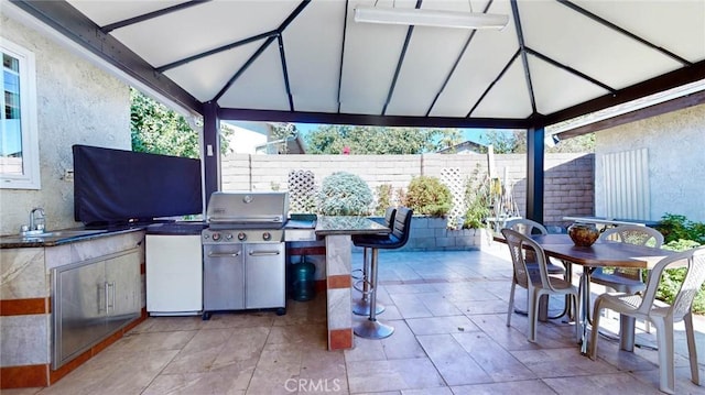 view of patio / terrace with a gazebo, exterior kitchen, and sink