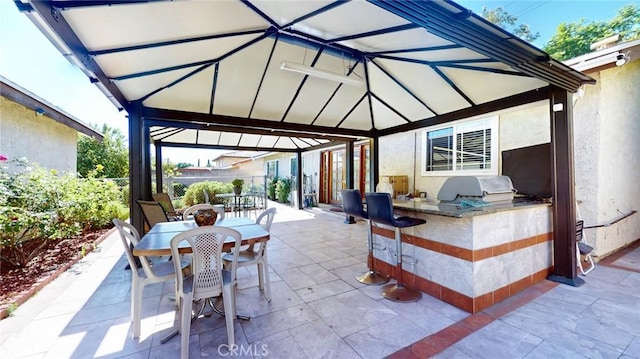 view of patio / terrace featuring an outdoor kitchen, a gazebo, and area for grilling