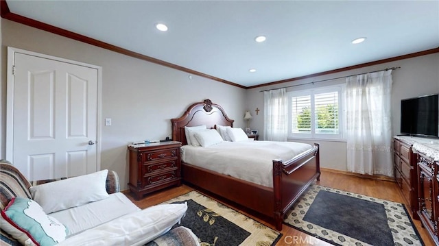 bedroom featuring ornamental molding and light hardwood / wood-style floors