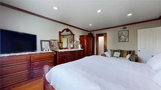 bedroom featuring light wood-type flooring and crown molding