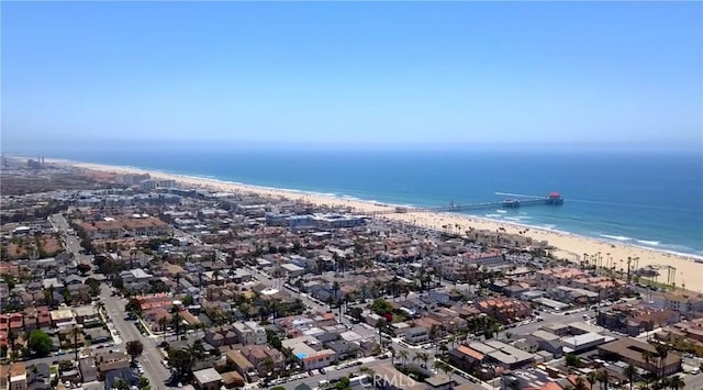 birds eye view of property featuring a beach view and a water view