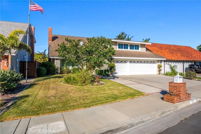 view of front of home featuring a garage and a front lawn