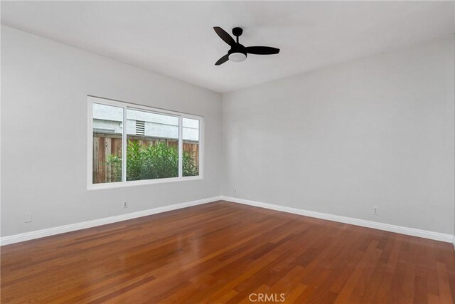 unfurnished room featuring ceiling fan and hardwood / wood-style flooring