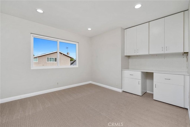 unfurnished office featuring light carpet