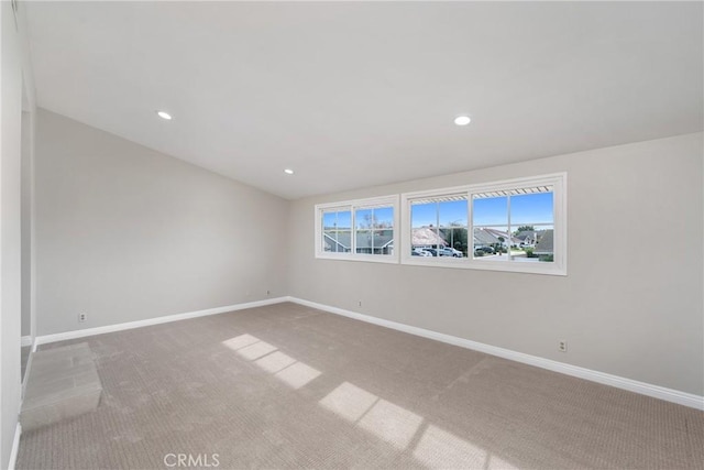 carpeted spare room with a healthy amount of sunlight, baseboards, and recessed lighting