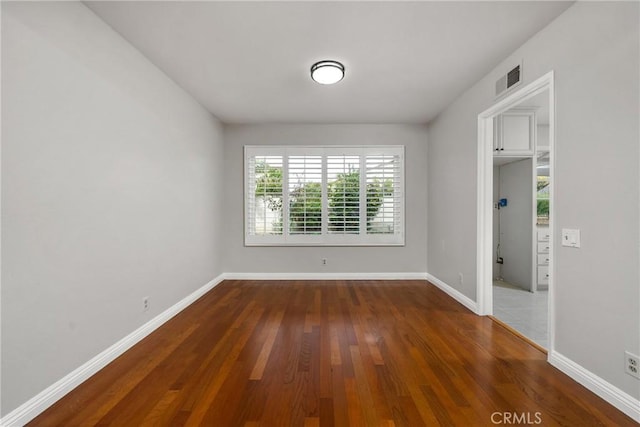 unfurnished room featuring dark hardwood / wood-style floors