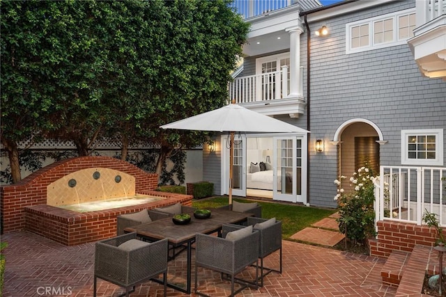 view of patio / terrace featuring an outdoor fire pit and a balcony