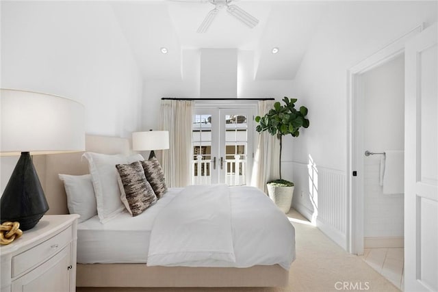 tiled bedroom with ceiling fan and vaulted ceiling